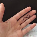 Balloon tattoo on the finger