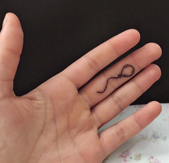 Balloon tattoo on the finger