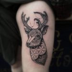 Black deer tattoo on the thigh