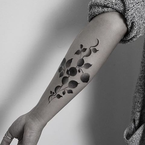Black floral tattoo on the arm