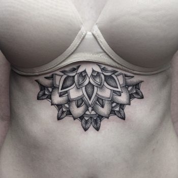 Black flower sternum tattoo