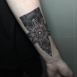 Black mandala tattoo on the wrist