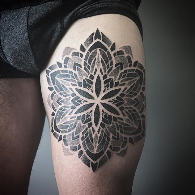 Black mandala tattoo on thigh