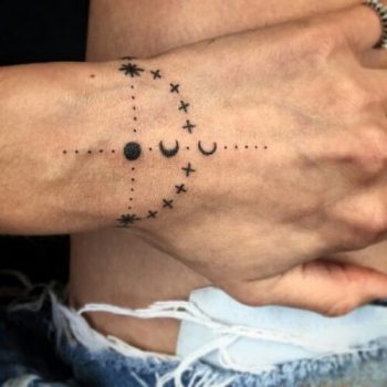Black minimal tattoo on the wrist
