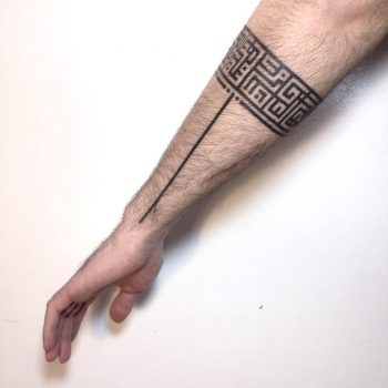 Black pattern tattoo on the arm