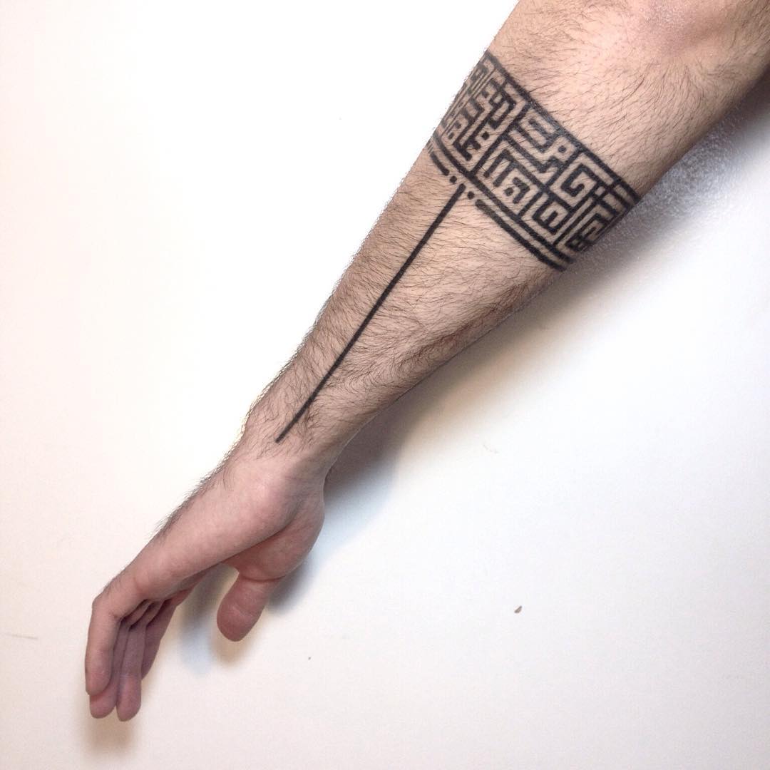 Black pattern tattoo on the arm 
