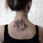 Black rose tattoo on the neck