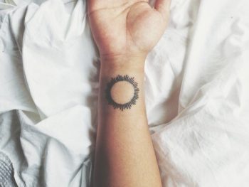 Black sun tattoo on the right wrist