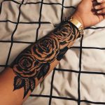 Black three roses tattoo on the left arm