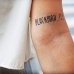 Blackbird fly quote tattoo on the left inner arm