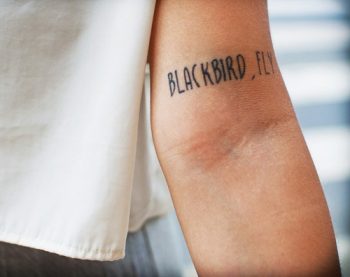 Blackbird fly quote tattoo on the left inner arm