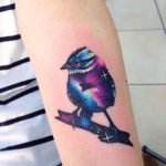 Cosmic bird tattoo