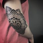 Dot work mandala tattoo on the elbow