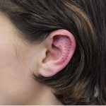 Dots tattoo on the ear