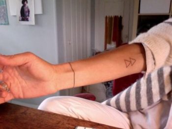Double triangle tattoo on the inner arm