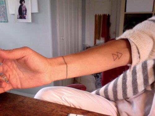 Double triangle tattoo on the inner arm 