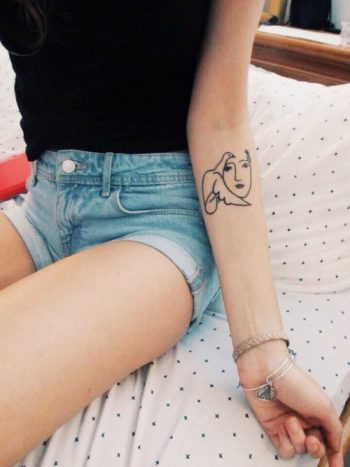 Dove and face tattoo