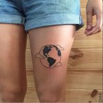 Earth tattoo on the thigh