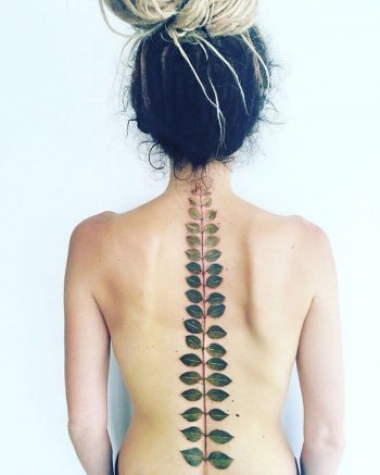 Fern leaf tattoo on the spine