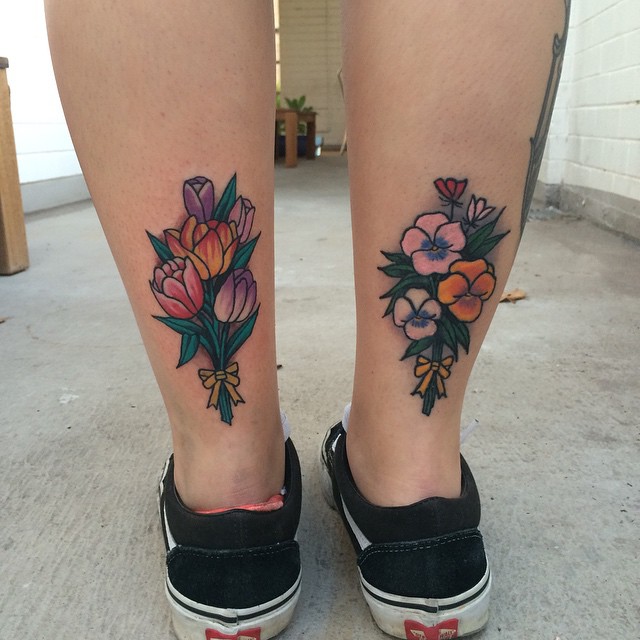 Flower bouquet tattoos on the calfs