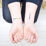 Gradient line tattoos on the wrists