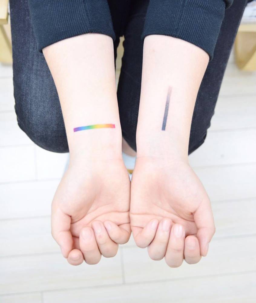 Gradient line tattoos on the wrists