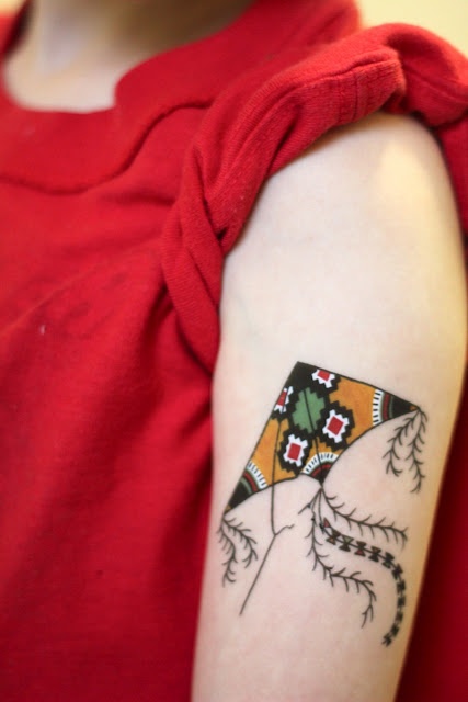 Mid-size kite tattoo on the left sleeve