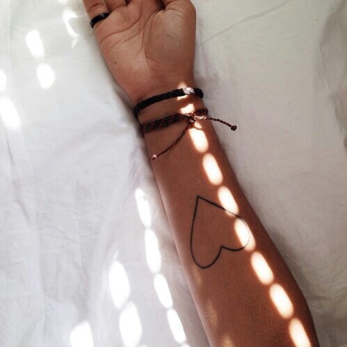 Minimal heart tattoo on the arm