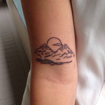 Mountains and sun tattoo
