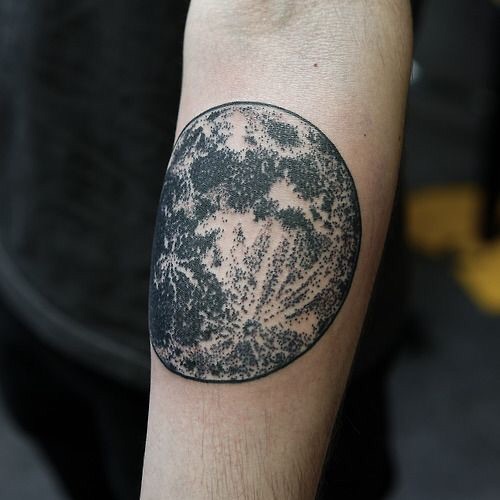 Micro-realistic full moon tattoo on the inner forearm.