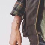 Small crescent moon tattoo on the wrist