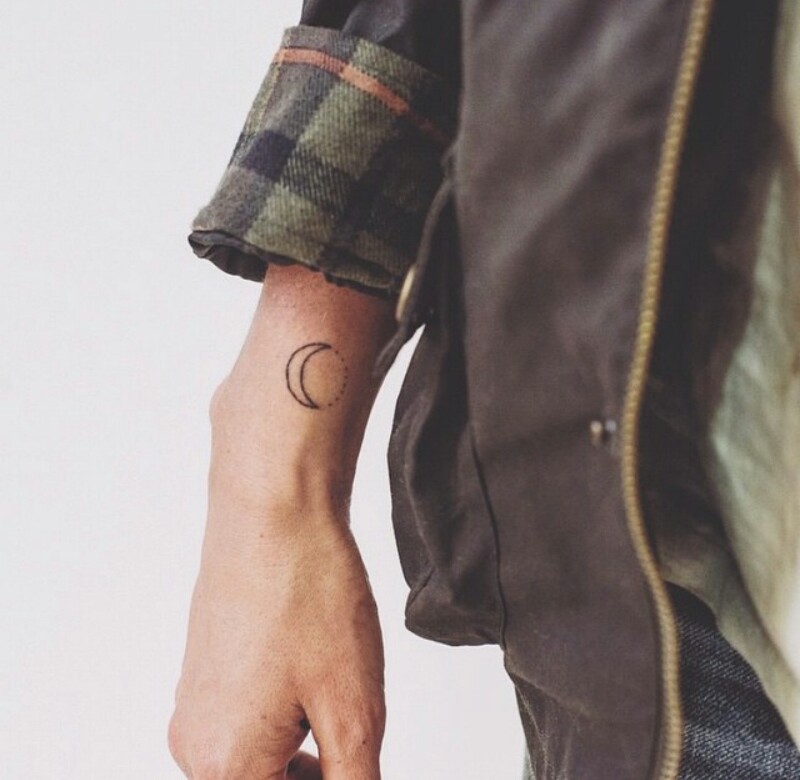 Small crescent moon tattoo on the wrist