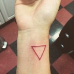 Small red triangle tattoo on the wrist