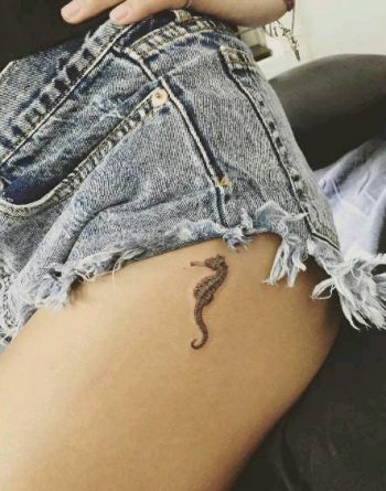 Small seahorse tattoo on the hip