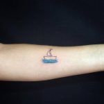 Small ship tattoo on the arm