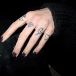 Symbol tattoos on the fingers