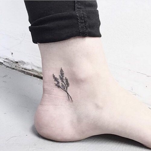 Tiny black flower tattoo