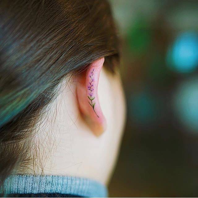 Tiny flower tattoo on the ear
