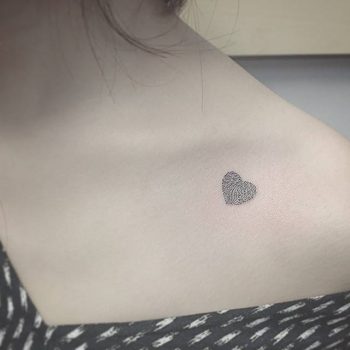 Tiny heart tattoo on the collarbone