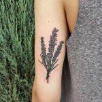 Wildflower bouquet tattoo on the back of the left arm