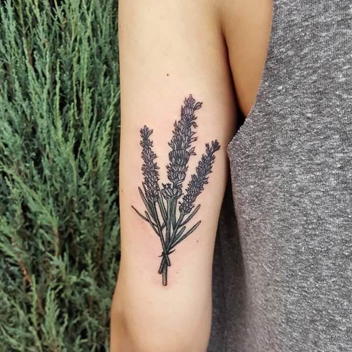 Wildflower bouquet tattoo on the back of the left arm