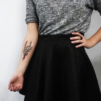 Wildflower tattoo bouquet on the right inner arm