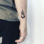Abstract black forearm tattoo
