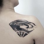 Abstract black tattoo on the shoulder blade