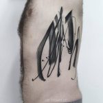 Abstract black tattoo on the side
