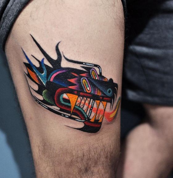 Abstract colorful tattoo on the thigh