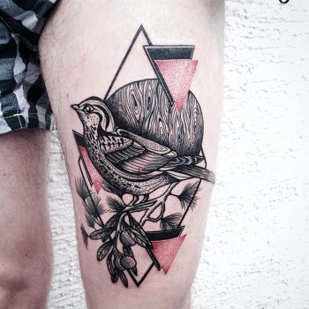 Bird tattoo on the thigh