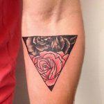 Black and red tose tattoo in a triangle
