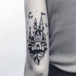 Black castle tattoo on the arm