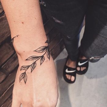 Black delicate botanical tattoo